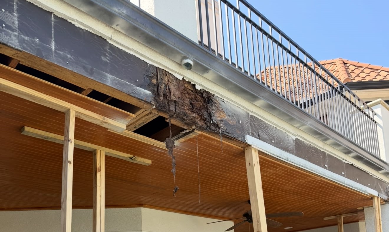 Wide view of concealed deterioration at the balcony beam edge